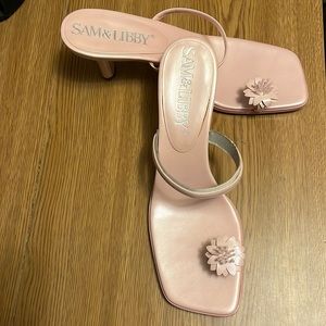 Pretty pink slip on sandal heel. Flower wraps around the big toe.